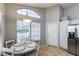 Bright breakfast nook features a white table set next to a window and stainless steel refrigerator at 363 W Bruce Ave, Gilbert, AZ 85233