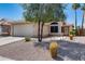 Inviting single-story home featuring a tile roof, two car garage and desert landscaping at 363 W Bruce Ave, Gilbert, AZ 85233