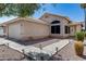 View of a home's front exterior and two car garage with a tile roof and desert landscaping at 363 W Bruce Ave, Gilbert, AZ 85233