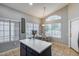 Bright eat-in kitchen with stainless refrigerator, white cabinets, and breakfast table at 363 W Bruce Ave, Gilbert, AZ 85233