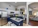 This kitchen features white and navy cabinets, stainless appliances, and an open design to the living room at 363 W Bruce Ave, Gilbert, AZ 85233
