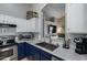 This kitchen area includes stainless appliances, white cabinets, and a view to the living room at 363 W Bruce Ave, Gilbert, AZ 85233