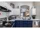 This kitchen area boasts white cabinets, stainless appliances and view into the living room at 363 W Bruce Ave, Gilbert, AZ 85233
