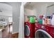 Laundry room featuring a red washer and dryer along with shelving for storage at 363 W Bruce Ave, Gilbert, AZ 85233