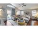 Bright living room with vaulted ceilings, wood floors, large sectional couch, and view to backyard at 363 W Bruce Ave, Gilbert, AZ 85233
