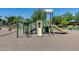 Community playground featuring slides and climbing structure surrounded by well-maintained, shady landscape at 363 W Bruce Ave, Gilbert, AZ 85233