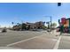 Busy intersection on a sunny day with local businesses and mature trees at 363 W Bruce Ave, Gilbert, AZ 85233