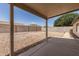 View of the backyard featuring a rock lawn, block fence, and covered patio at 3646 E Rousay Dr, San Tan Valley, AZ 85140