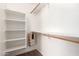 Bright closet with wood bar for hanging clothes, shelving, and carpeted floor at 3646 E Rousay Dr, San Tan Valley, AZ 85140
