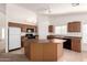 Bright kitchen featuring an island, sleek appliances, and ample counter space at 3646 E Rousay Dr, San Tan Valley, AZ 85140