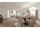 Open-concept living and dining area with vaulted ceilings and ample natural light showcases modern elegance and comfortable living at 3646 E Rousay Dr, San Tan Valley, AZ 85140