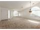 Bright, open living room with arched windows, neutral carpet, and a unique chandelier fixture at 3646 E Rousay Dr, San Tan Valley, AZ 85140