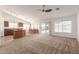 Open-concept living area with neutral carpet, vaulted ceilings, open kitchen, and access to the backyard at 3646 E Rousay Dr, San Tan Valley, AZ 85140