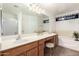Main bathroom with dual sinks, shower, and soaking tub at 3646 E Rousay Dr, San Tan Valley, AZ 85140