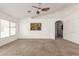 Serene main bedroom with neutral carpet, ceiling fan, and a view of the backyard, plus large closet at 3646 E Rousay Dr, San Tan Valley, AZ 85140