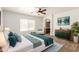 Serene main bedroom with a ceiling fan, stylish furniture, and an ensuite bathroom creates a peaceful retreat at 3646 E Rousay Dr, San Tan Valley, AZ 85140