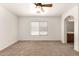 This main bedroom has a window and arched doorway leading to the main bathroom at 3646 E Rousay Dr, San Tan Valley, AZ 85140