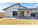 A backyard featuring a covered patio, ample grass, and sliding glass doors into the home at 3651 W Escuda Dr, Glendale, AZ 85308