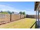 A backyard with a grass lawn, block wall, and a view of neighboring houses and trees at 3651 W Escuda Dr, Glendale, AZ 85308