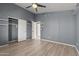 A modern bedroom with a vaulted ceiling, wood-look flooring and closet at 3651 W Escuda Dr, Glendale, AZ 85308