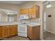 Functional kitchen featuring white appliances, wood cabinets, and tile flooring at 3651 W Escuda Dr, Glendale, AZ 85308