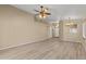 Spacious living room with wood-look floors, ceiling fan, and neutral walls at 3651 W Escuda Dr, Glendale, AZ 85308