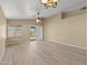 Bright living room featuring new floors, contemporary lighting, and sliding glass doors to the back at 3651 W Escuda Dr, Glendale, AZ 85308