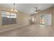 Bright living room featuring new floors, contemporary lighting, and sliding glass doors to the back at 3651 W Escuda Dr, Glendale, AZ 85308