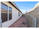 Side yard showing house, window, block wall, and chain link fence at 3651 W Escuda Dr, Glendale, AZ 85308