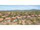 An aerial view of homes featuring private pools, mature landscaping, and picturesque mountain views at 4131 E Cascalote Dr, Cave Creek, AZ 85331