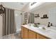 Clean bathroom with a dual sink vanity and a shower-tub combo at 4131 E Cascalote Dr, Cave Creek, AZ 85331
