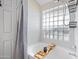 Bright bathroom featuring glass block window, soaking tub with bath caddy, and rainfall shower head at 4131 E Cascalote Dr, Cave Creek, AZ 85331