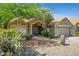Inviting home showcasing lush desert landscaping, tile roof, and a covered front entrance at 4131 E Cascalote Dr, Cave Creek, AZ 85331
