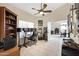 Comfortable home office with custom shelving, a ceiling fan, and a dedicated workspace at 4131 E Cascalote Dr, Cave Creek, AZ 85331