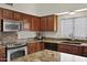 Spacious kitchen featuring stainless steel appliances, stone countertops, and wood cabinetry at 4131 E Cascalote Dr, Cave Creek, AZ 85331