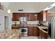 Well-lit kitchen boasts stainless steel appliances, wood cabinets, and beautiful countertops at 4131 E Cascalote Dr, Cave Creek, AZ 85331