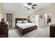 Spacious main bedroom with a fan, exterior access, and a private bathroom and closet at 4131 E Cascalote Dr, Cave Creek, AZ 85331