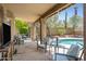 Covered patio overlooking a refreshing pool with lounge seating and lush landscaping for relaxation at 4131 E Cascalote Dr, Cave Creek, AZ 85331