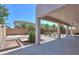 Backyard featuring a patio area, landscaping, and horseshoe pits at 43561 W Snow Dr, Maricopa, AZ 85138