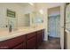 Bathroom featuring a double sink vanity, a bathtub, and a separate shower stall at 43561 W Snow Dr, Maricopa, AZ 85138