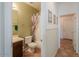 Bright bathroom featuring a vanity, toilet, and shower-tub combo with floral curtain at 43561 W Snow Dr, Maricopa, AZ 85138