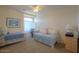 This carpeted bedroom features a daybed, a desk, and a chest of drawers at 43561 W Snow Dr, Maricopa, AZ 85138