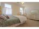 Bedroom with carpeted floor, dresser, a decorative bed frame, and a matching mirror at 43561 W Snow Dr, Maricopa, AZ 85138