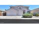 Charming two-story home with well-manicured landscaping and a spacious three-car garage at 43561 W Snow Dr, Maricopa, AZ 85138