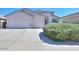 Well maintained single story home featuring a spacious three-car garage and desert landscaping at 43561 W Snow Dr, Maricopa, AZ 85138