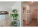 Hallway leading to bathroom and kitchen, showcasing tile flooring at 43561 W Snow Dr, Maricopa, AZ 85138