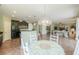 Open floor plan view of the kitchen with granite countertops, stainless appliances and a dining area at 43561 W Snow Dr, Maricopa, AZ 85138