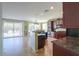 Well-lit kitchen offering ample countertop space, dark wood cabinets and an expansive view into the backyard at 43561 W Snow Dr, Maricopa, AZ 85138
