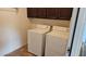 Laundry room with washer and dryer units, and wooden cabinets at 43561 W Snow Dr, Maricopa, AZ 85138