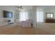 Bright living room with carpet flooring, white curtains and ceiling fan at 43561 W Snow Dr, Maricopa, AZ 85138